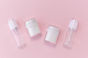 Reusable glass white bottles for oil, cream, lotion or serum on a pink background. Zero waste, eco-friendly. Layout of the beauty salon branding. Natural cosmetics