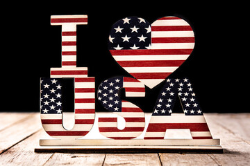 Fototapeta na wymiar I love USA and stars ornament on woode table and black background
