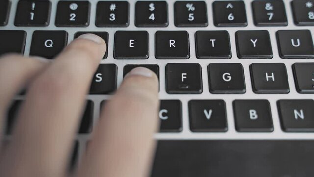 Man is playing a game on a laptop keyboard in the office when he was supposed to be working. Gaming addiction is bad for work