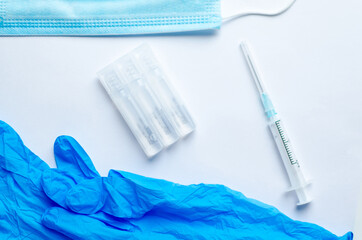 vaccination against coronavirus ampoule syringe mask and blue gloves