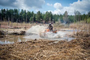 Atv rider in muddy water. Xtreme utv ride