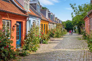 Fototapeta na wymiar Aarhus, Denmark; May 30th, 2021 - Colourful old cottages on a quiet street in Aarhus, Denmark 
