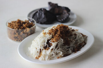 String hoppers, a steamed rice noodle dish with grated cocunut and palm jaggery filling.