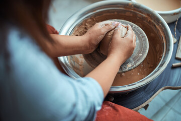 Young woman hands making pottery in workshop