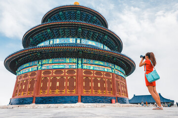 China travel tourist woman on vacation in Beijing taking pictures with camera of worship temple of...