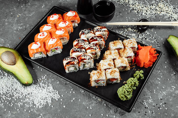 Sushi set with fresh ingredients on gray background. Sushi menu. Japanese food