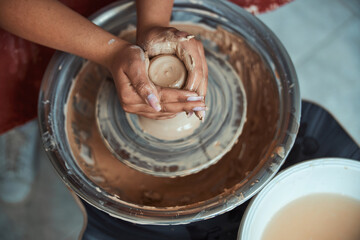 Female potter hands making pottery in workshop