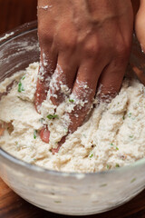 Close-up of Preparation of  dahi vada - mixture of grind urad dal with condiments and ingredients and roasted cumin and green fresh coriander for preparation of chaat.