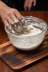 Close-up of Preparation of  dahi vada - mixture of grind urad dal with condiments and ingredients and roasted cumin and green fresh coriander for preparation of chaat.