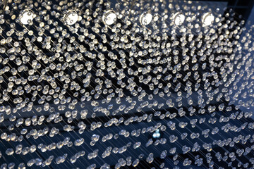 Crystal curtains illuminated by ceiling lights. Crystal balls suspended from ropes.