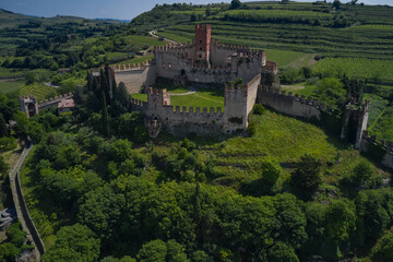 Soave castle aerial view, province of Verona, Italy. The famous medieval castle on the hill. Italian historic castles.