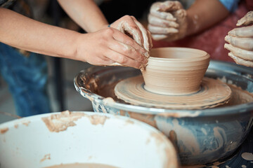 Fototapeta na wymiar Potter hands making clay bowl in pottery workshop