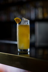 long glass drink with orange peel