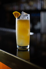 long glass drink with orange peel