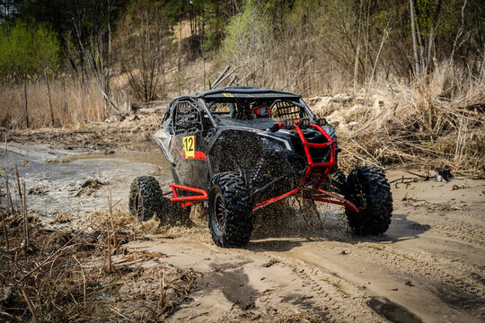 Offroad vehicle in the action and makes splashes of dirty water