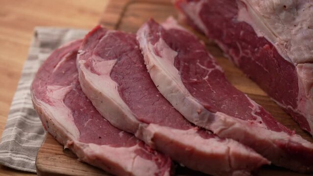 chef cutting block of ribeye beef steak, slow motion 4k 120p