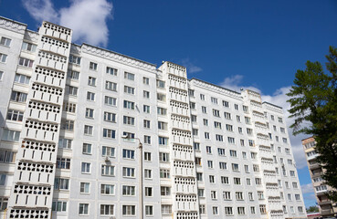 Obraz premium View from below on the facade of a modern multi-storey building with beautiful balconies