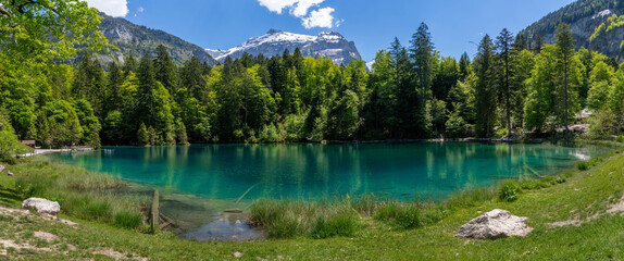 The scenic mountain lake Blausee located in the Kander valley above Kandergrund in the Jungfrau region, Switzerland.