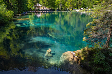 The scenic mountain lake Blausee located in the Kander valley above Kandergrund in the Jungfrau region, Switzerland.