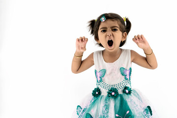 Funny indian / Asian little girl imitating tiger over white studio background. The girl holds her hands in front of her and imagines that she is a tiger, baby on a white background.