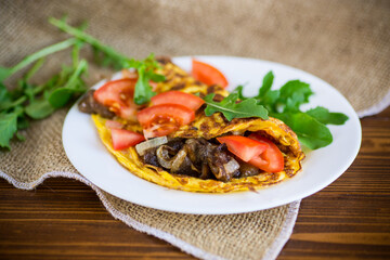 fried egg omelet with wild mushrooms and tomatoes