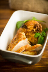 baked chicken fillet pieces with spices and herbs, in a ceramic form