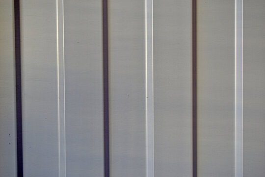 Silver profiled flooring close up bent during the day
