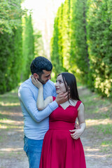 woman in red dress with boyfriend in the park, young couple in the park