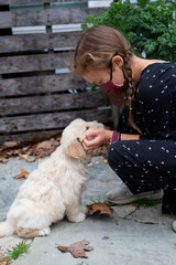 Little Girl Playing With Golden Retriever Puppy