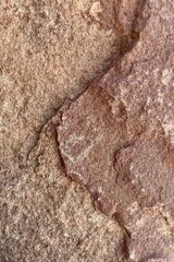 Details closeup of vertically isolated solid weathered rock background, vintage rough old stone texture