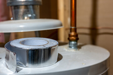 selective focus on the edge of a roll of metallic aluminum foil HVAC duct tape