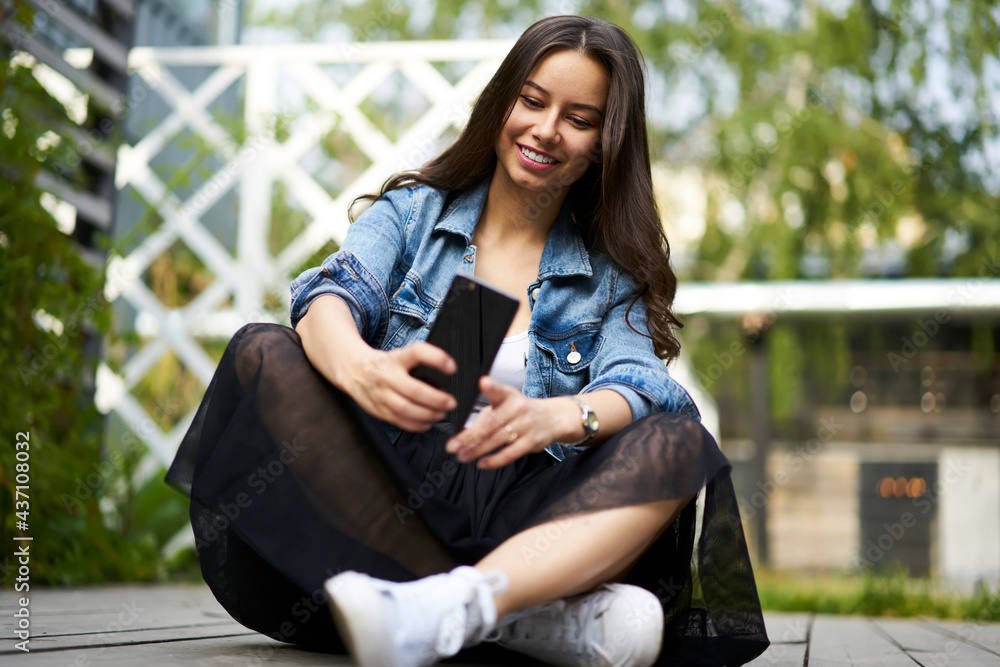 Poster funny millennial vlogger smiling at front mobile camera while shooting video for sharing to network 