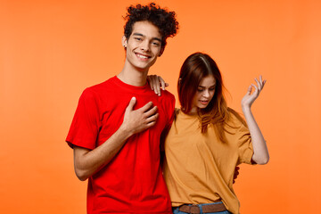 Fototapeta premium funny guy and girl in multicolored t-shirts modern style fashion