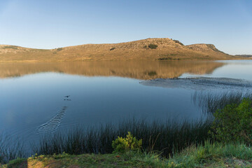 Small lagoon at the foot of the mountain ranges in the countryside of Argentina