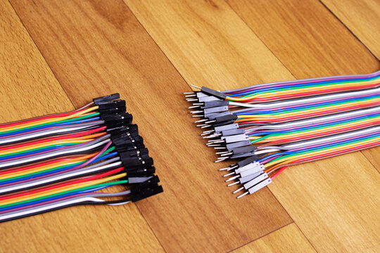 Set of multicolored wires on wooden background