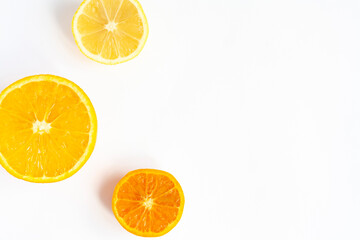 Fresh citrus fruit halves on a white background, copy space