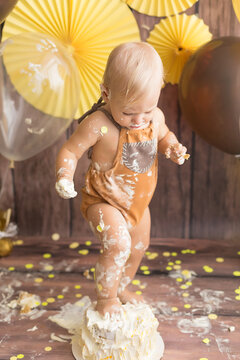 celebration of the first birthday. the boy smashes his first cake. cake smash photo session. baby blond