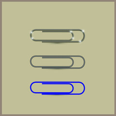 Set office paper clips. Metal, iron, plastic paper clip on a beige background.