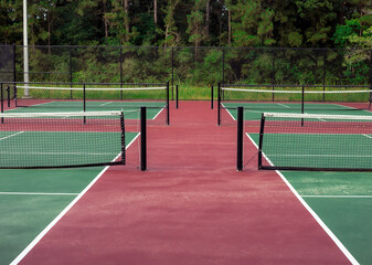 a view down the center of four pickle ball courts at a public park in Conroe, TX
