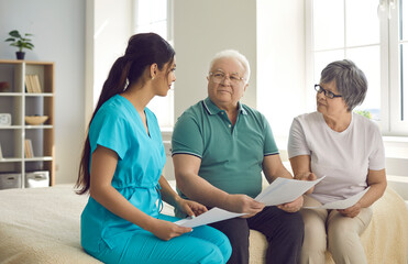 Caretaker helps senior patients sign homecare agreement, fill informed exam consent, understand...