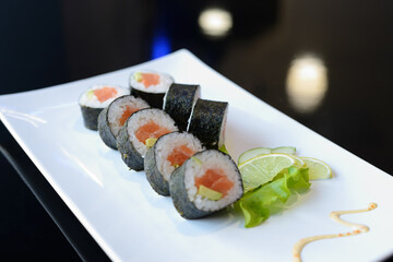 Sushi rolls on white dish. Japanese food.