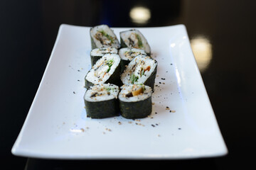 Sushi rolls on white dish. Japanese food.