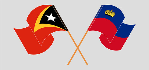 Crossed and waving flags of East Timor and Liechtenstein