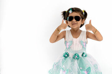 Portrait of little cute asian girl wearing dark sun glass with her thump up, advertisement concept, little asian teenage thumps up with white background and empty space at left, Stuido Shot