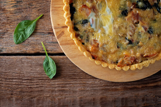 bacon spinach quiche with fresh spinach leaves
