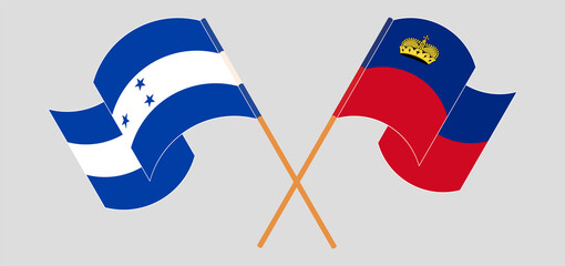 Crossed and waving flags of Honduras and Liechtenstein