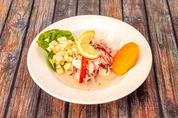 Fish ceviche made with Peruvian recipe with strips of red pepper, red onion and sweet potato slice