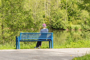 A person sitting lonely on a park bench