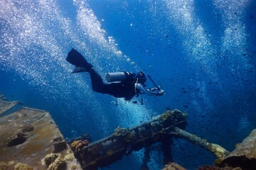 Scuba diver exploring a shipwreck in Malasia. 