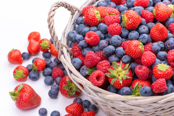 Basket with berries. Raspberries, strawberries and blueberries. Isolate